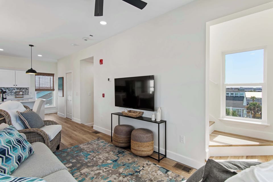 Unwind in your bright living space with modern furnishings, smart TV, and glimpses of city views through picture windows.