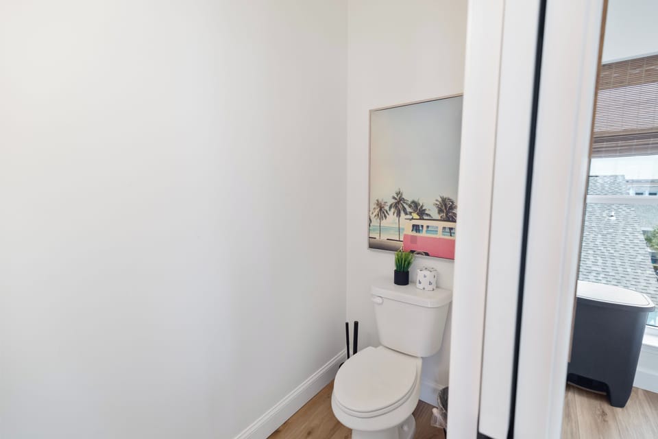 Your private bathroom is fresh, clean, and thoughtfully appointed—featuring a cheerful touch of coastal art that adds personality to the space.