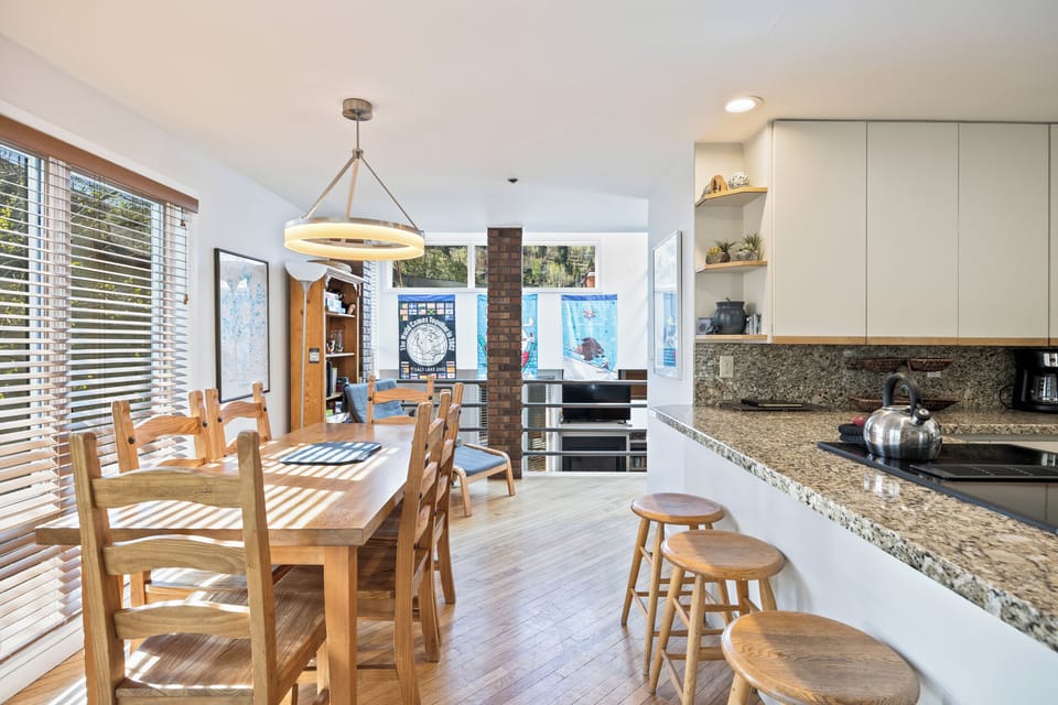 Bright dining space with seating for multiple guests, seamlessly connected to the kitchen for easy entertaining.
