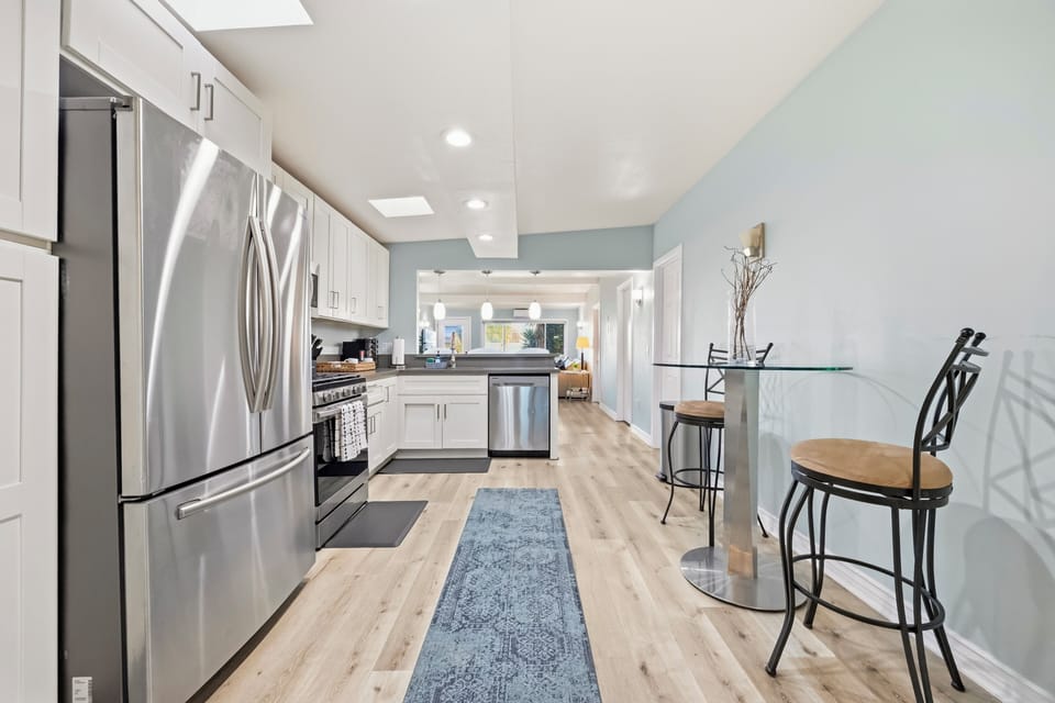 Updated kitchen with stainless steel appliances, ample cabinetry, and a spacious layout perfect for cooking and gathering.