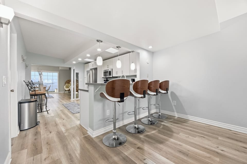 Modern kitchen featuring a breakfast bar with seating, sleek finishes, and an open layout for easy entertaining.