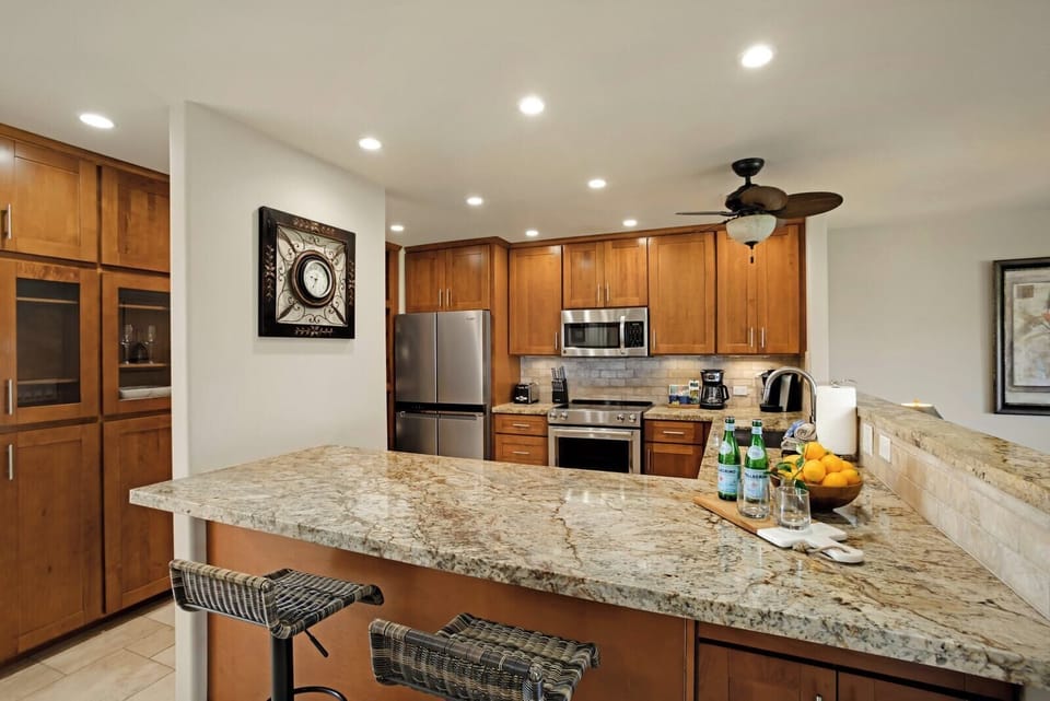 Modern gourmet kitchen with granite countertops and stainless steel appliances. KRO-L201