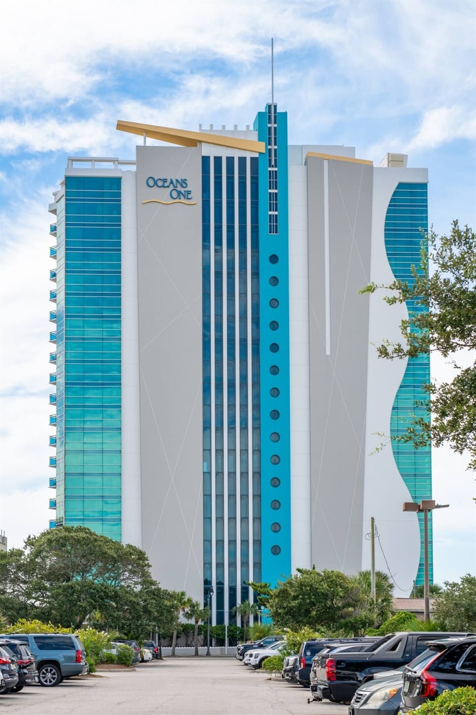 Stunning beachfront high-rise resort with expansive balconies, modern design