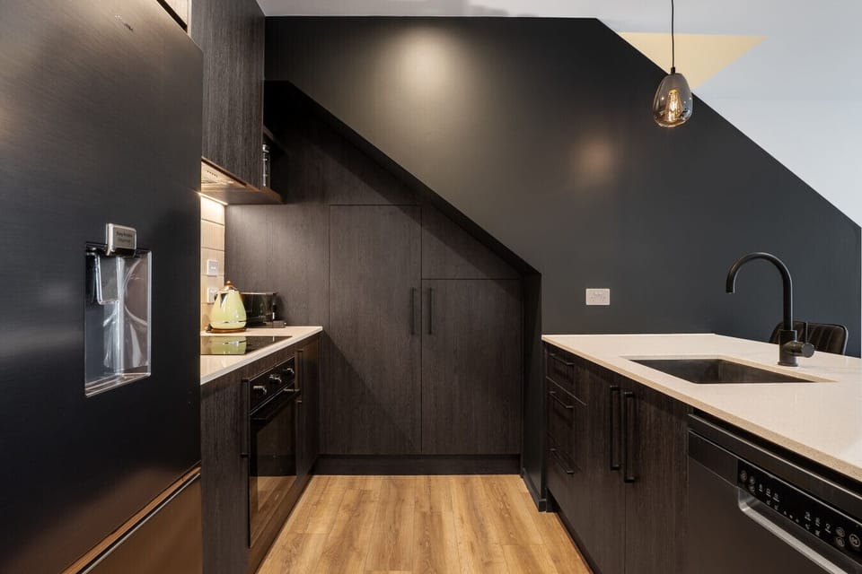 Kitchen features a full size fridge/freezer and dishwasher
