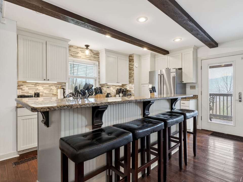 Modern kitchen island with granite countertops and breakfast bar seating