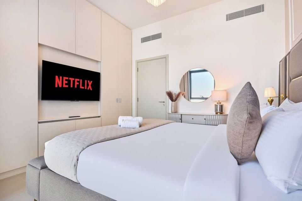 Luxurious king-size bed with stylish lighting and entertainment TV