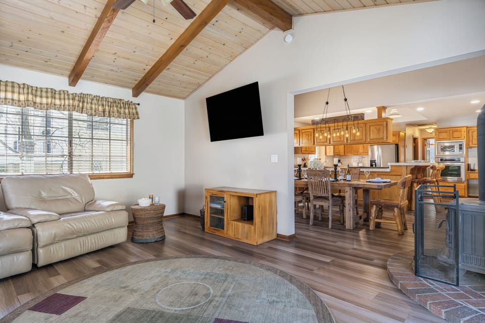 Living room with a fireplace, foosball table, and arcade machine for laid-back cabin nights.