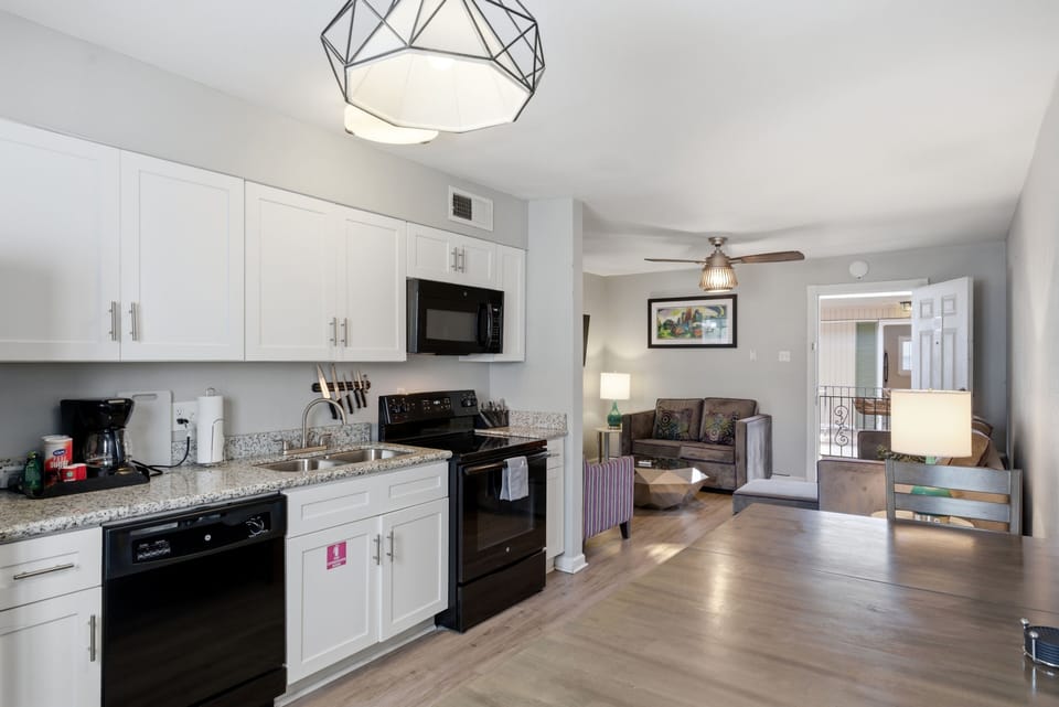 Fully equipped kitchen w/ modern appliances & a dedicated dining space.
