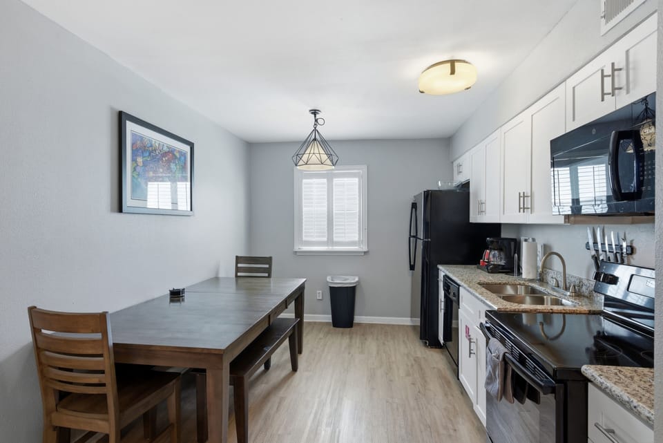 Sleek kitchen & dining area w/ everything you need to cook & gather.
