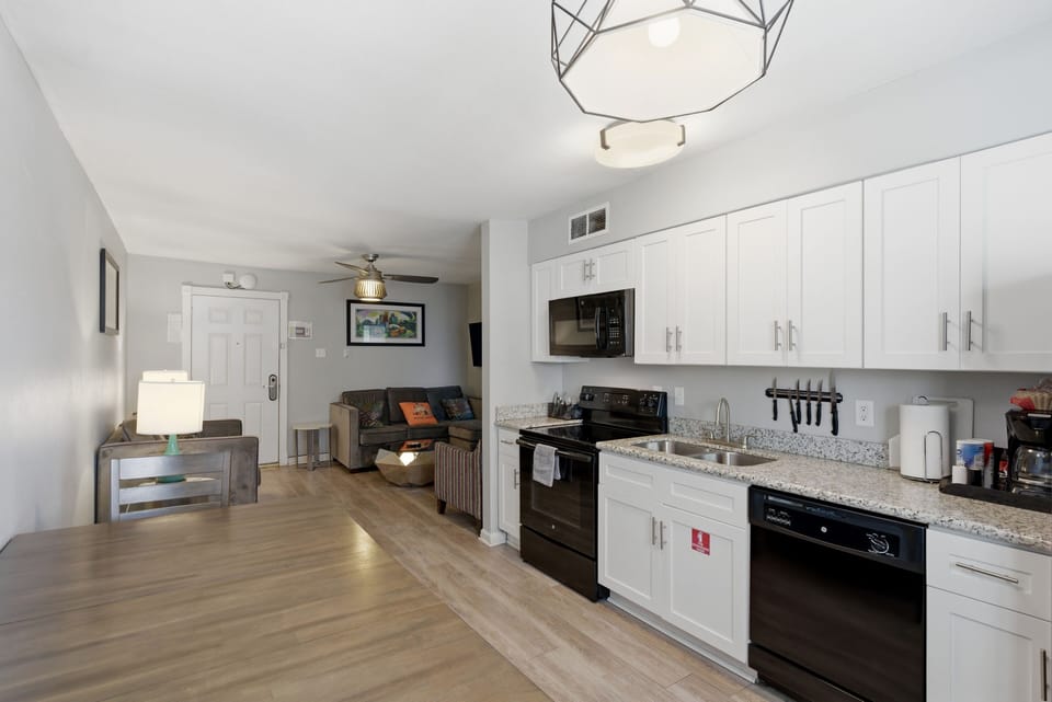 Fully equipped kitchen w/ modern appliances & dining space for meals at home.
