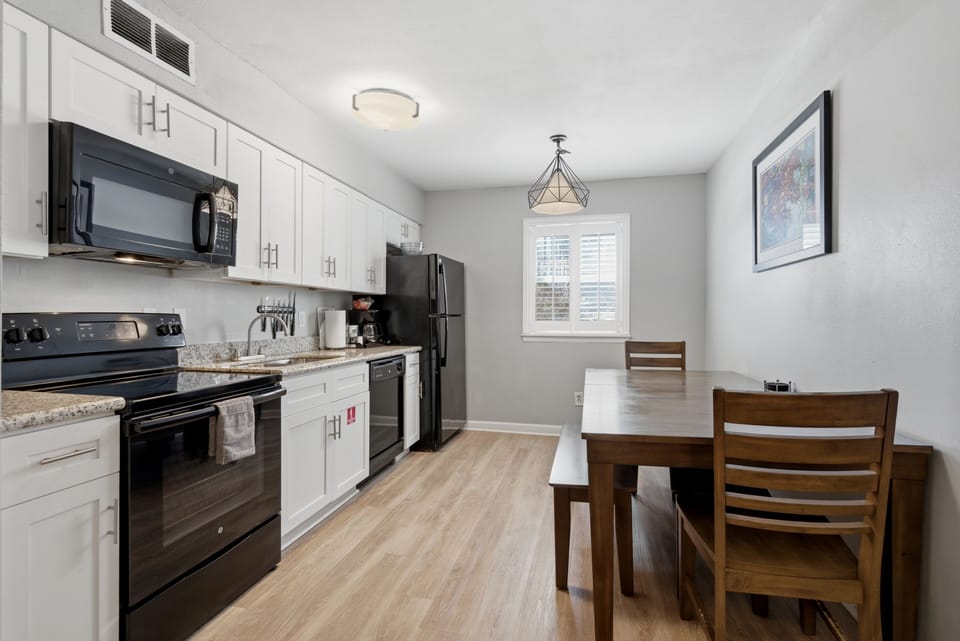 Sleek kitchen w/ modern appliances & a dining area ready for every meal.
