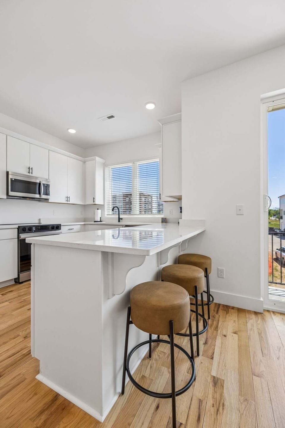 2nd Floor: Full kitchen with barstool seating at breakfast bar for additional dining seating
