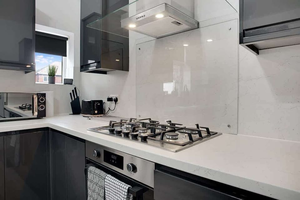 Kitchen equipped with all essentials, including a washer & dryer, oven, fridge and full cookware set.