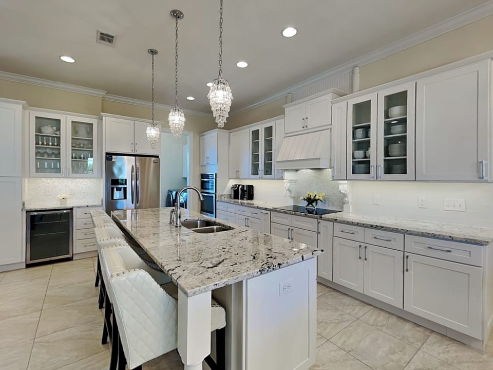 Fully Equipped Kitchen with Stainless Steel Appliances and Bar Seating - First Floor