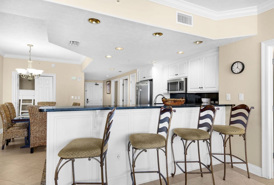Your spacious kitchen invites culinary adventures with granite countertops, stainless appliances, and breakfast bar seating for casual meals together.