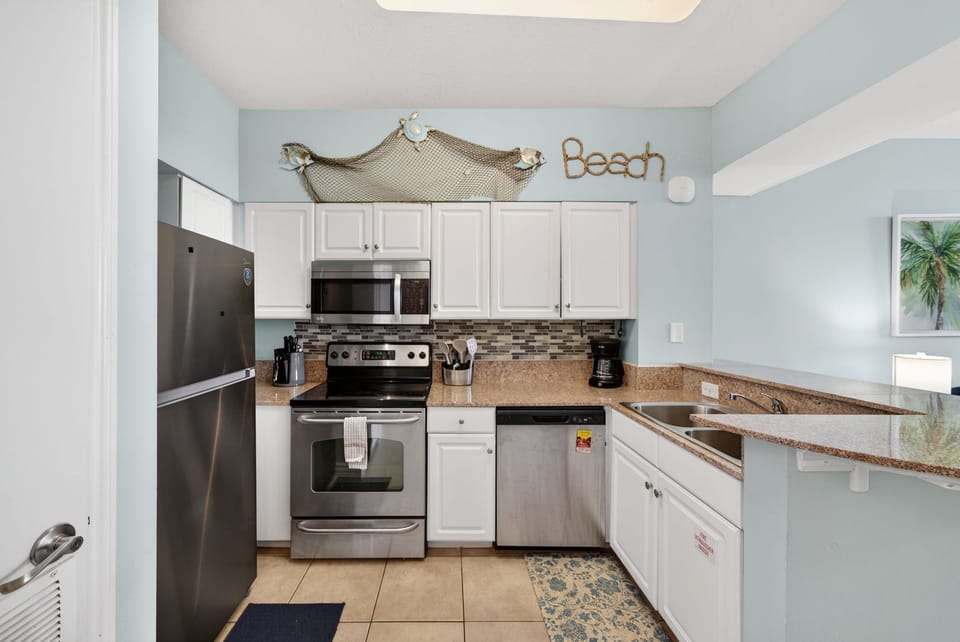 Your beach-themed kitchen awaits with granite counters, stainless appliances, and coastal charm that makes cooking feel like vacation.