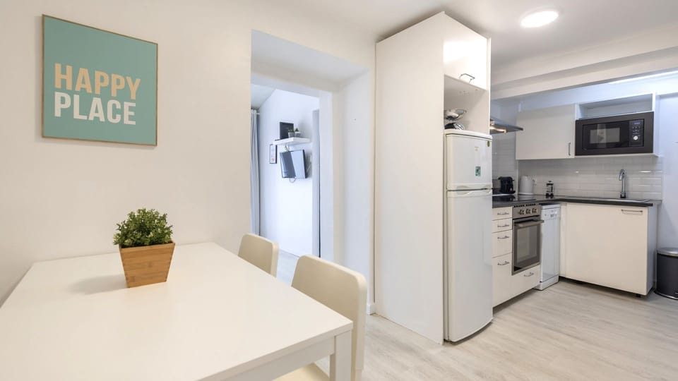 A modern kitchenette and dining area with white walls, a small dining table, and appliances, including a refrigerator, stove, and microwave.
#KitchenGoals #ModernKitchen #DiningArea #HomeCooking #InteriorStyle #MinimalistKitchen