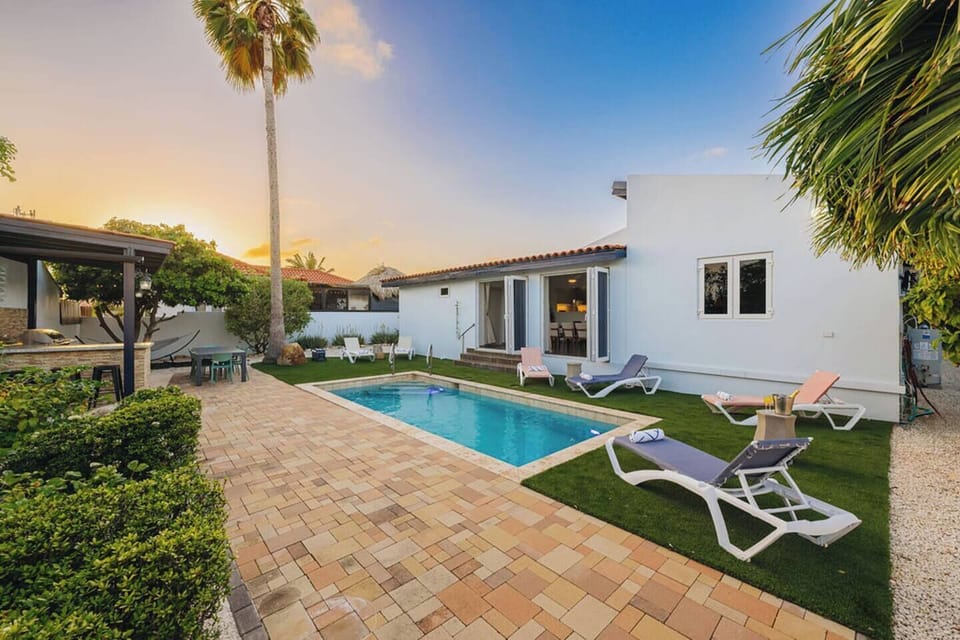Golden hour by the pool with a fully private backyard setting.