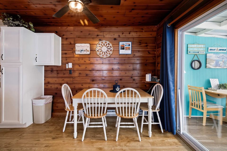 Main dining space offers seating for four beside the screened porch.