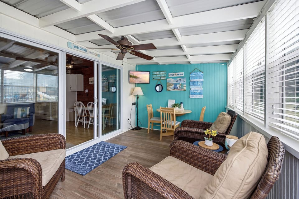 Screened porch includes a dining nook, TV, and lounge seating for everyone.