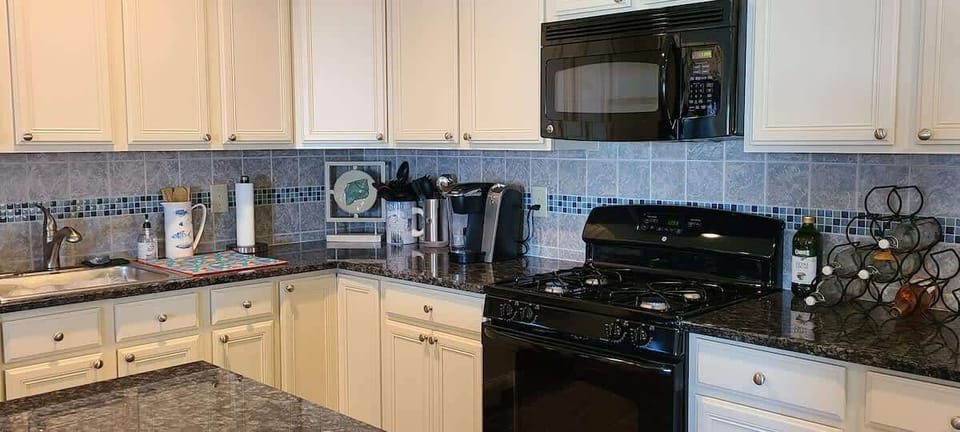 2nd floor gourmet kitchen complete with coffee makers (standard and keurig), dishwasher, microwave and all cooking necessities (pots/pans/plates/cups).  We have received many compliments just how well stocked our kitchen(s) are.