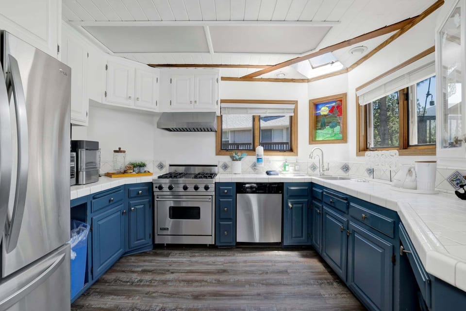 Fully equipped cabin kitchen with ample cabinetry, stove, fridge, and coffee maker—perfect for cooking meals, morning coffee, and feeling right at home on your stay.