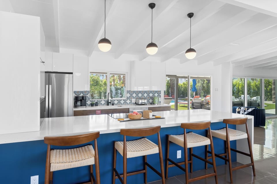 Your modern kitchen features a spacious island with stylish bar seating, perfect for morning coffee or casual dining together.
