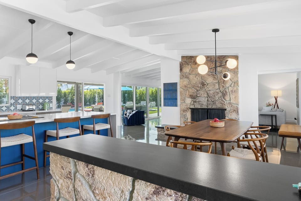 Gather around this stunning open-concept kitchen and dining space where your group can cook, dine, and relax together under soaring beamed ceilings.