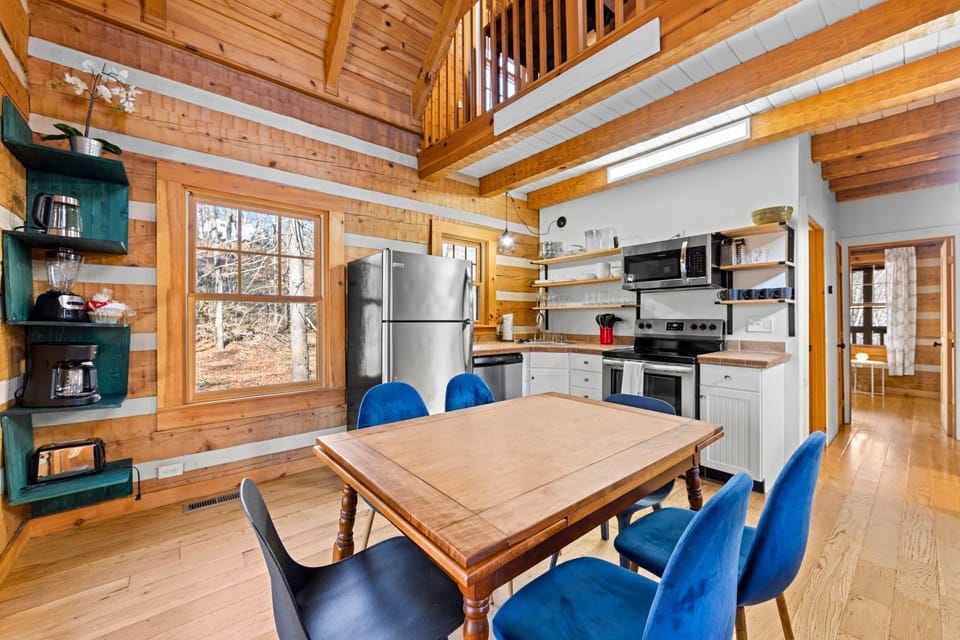 Savor meals at the charming dining table, set against a backdrop of rustic wood and natural light.