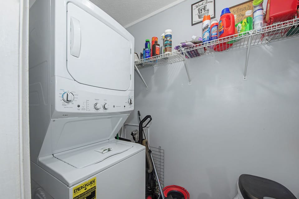 Your private laundry room keeps you organized with a stackable washer-dryer and convenient storage shelves for all your essentials.