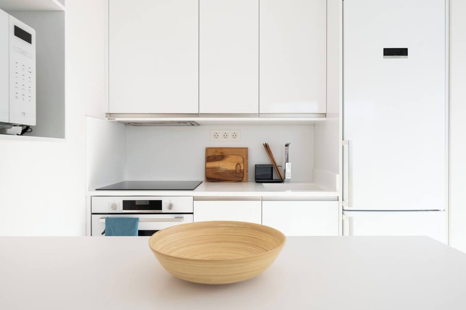 Kitchen with modern and functional cabinetry, including cupboards, countertops, and built-in appliances