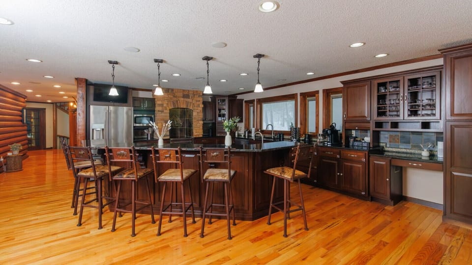 Large kitchen with island seating and coffee bar supports shared breakfasts, celebrations, and multi-family vacation meals