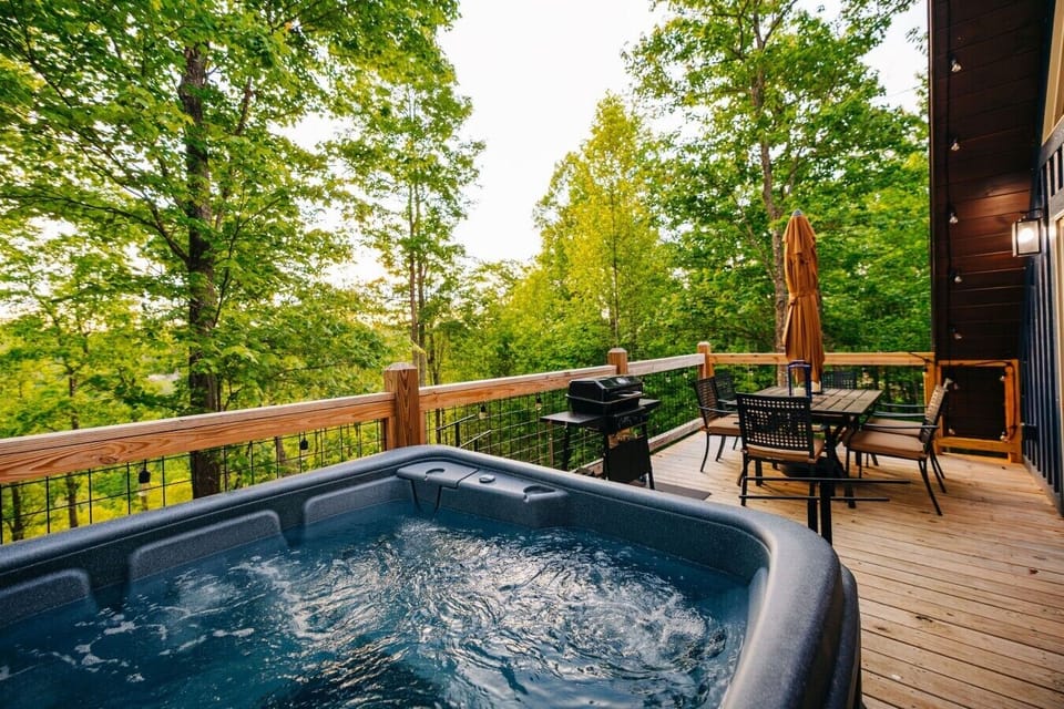 Soak in the hot tub while friends prep dinner nearby on the private deck with peaceful forest views