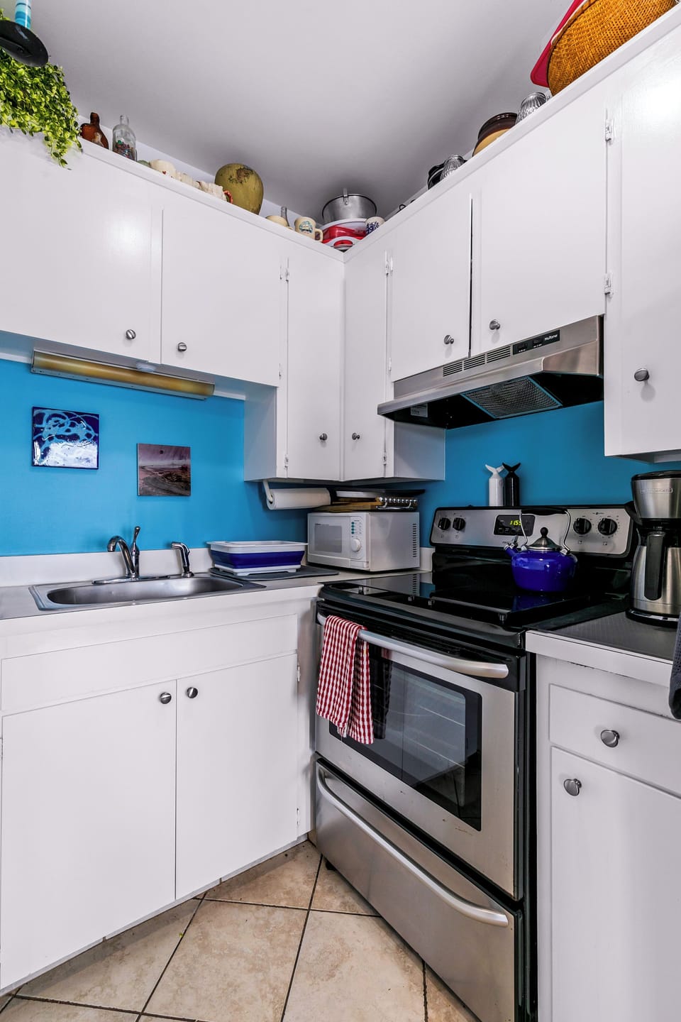 Bright, fully equipped kitchen with stainless range and coffee station