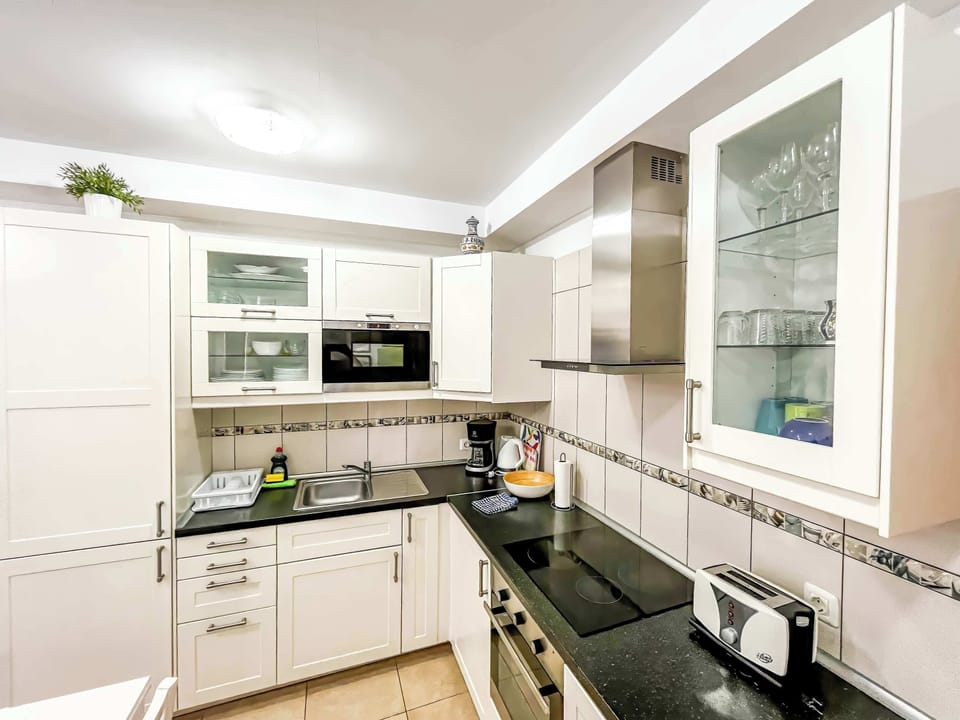 A fully equipped kitchen allows you to prepare your own meals. It includes a coffee maker, cookware, dishes, silverware, microwave, oven, and refrigerator. 
