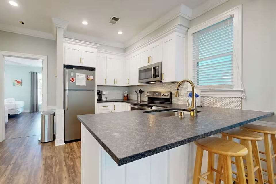 Your fully equipped kitchen features modern appliances, elegant countertops, and a breakfast bar perfect for morning coffee or casual meals.
