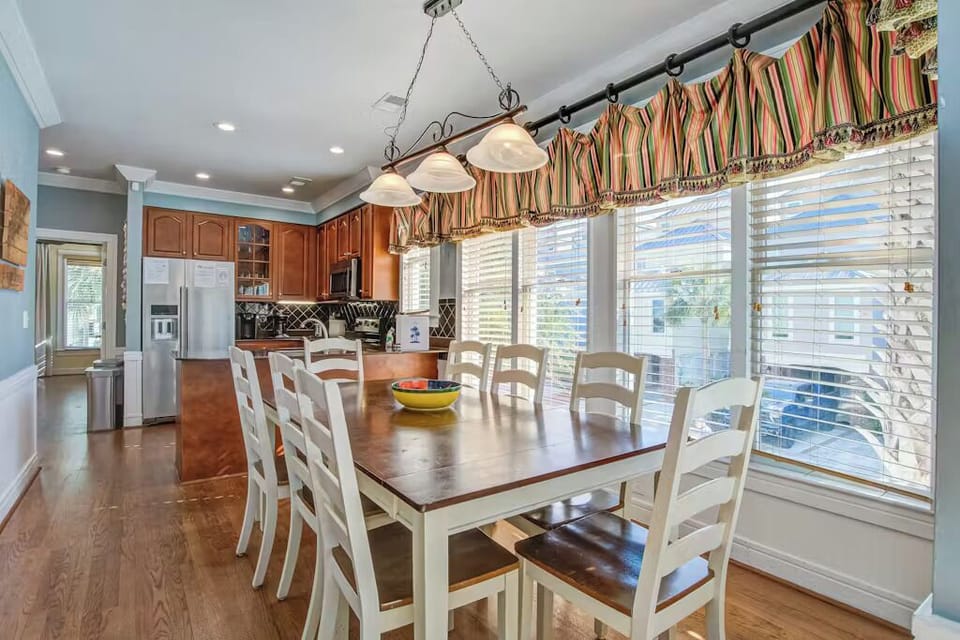 Your open-concept kitchen and dining area features warm wood cabinetry, stainless appliances, and a welcoming table for memorable meals together.