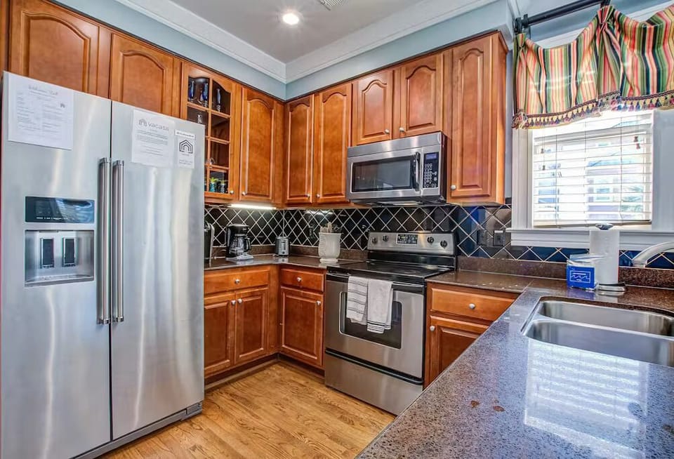 Your fully-equipped kitchen features warm wood cabinets, stainless steel appliances, and granite counters - perfect for preparing memorable meals.