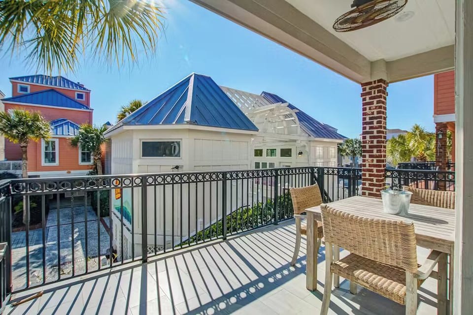 Sip your morning coffee on this covered balcony while taking in views of charming coastal architecture and swaying palms.