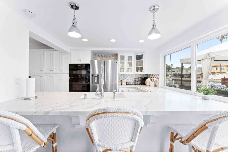 The large kitchen island comfortably sits 3 guests.
