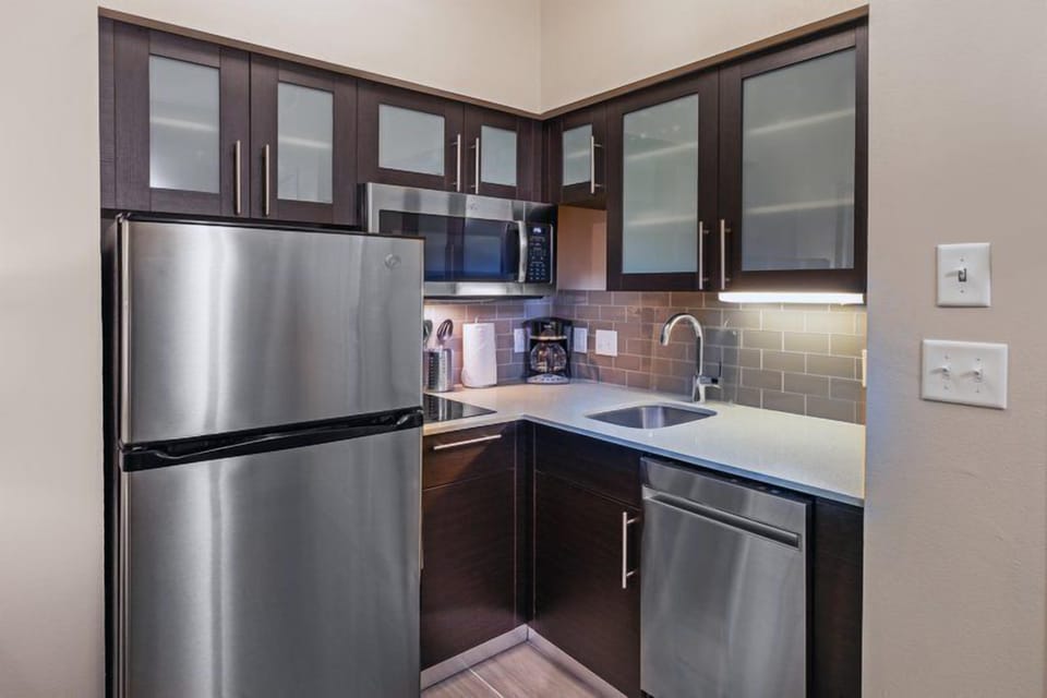 Cook up a storm in this fully-equipped kitchen, featuring stainless appliances and sleek cabinetry.