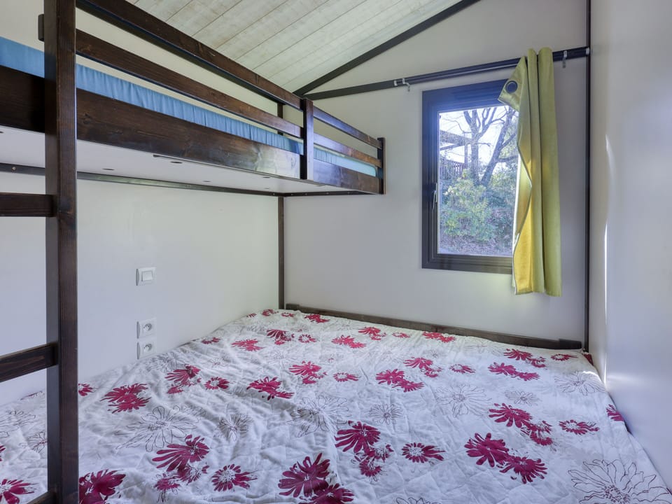 Relax in this cozy bedroom featuring a comforting double bed and a window that brings the outdoors in.