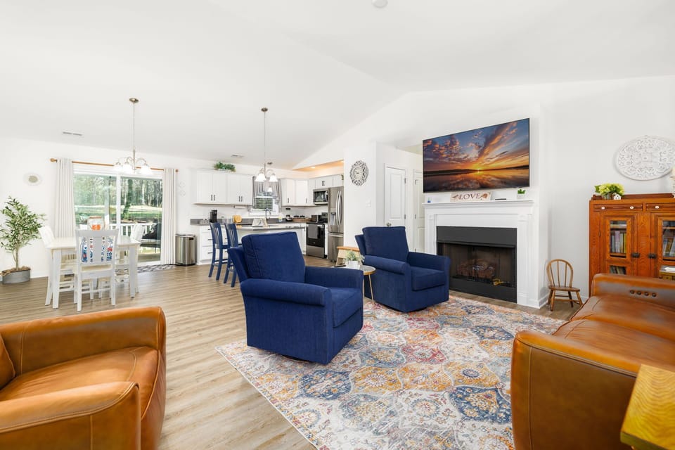 Gas fireplace with 65” Smart TV for cozy evenings indoors.