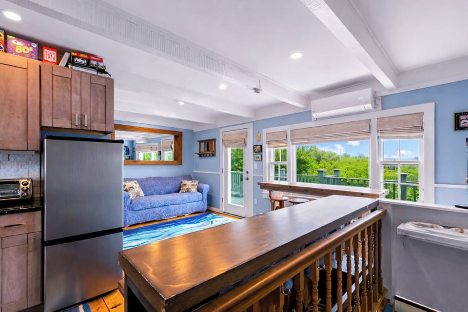 Bright open living with deck views, AC, and cozy kitchen-lounge