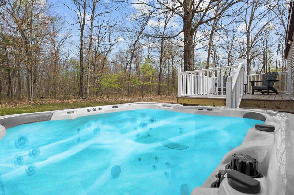 Soak the day away in your private hot tub with a relaxing forest view