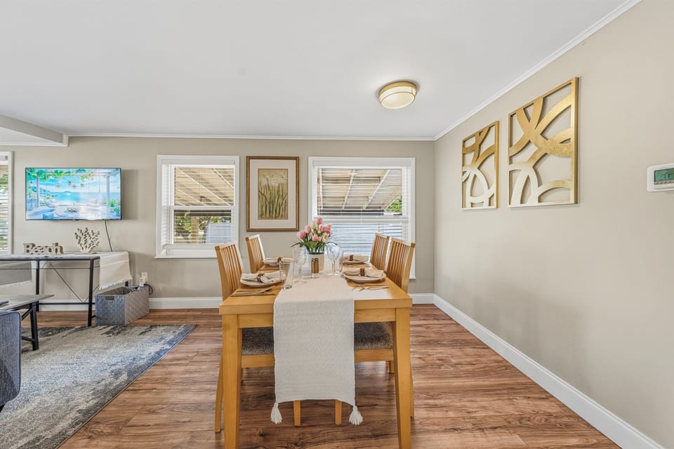 Bright dining space overlooking the cozy living room—perfect for shared meals.