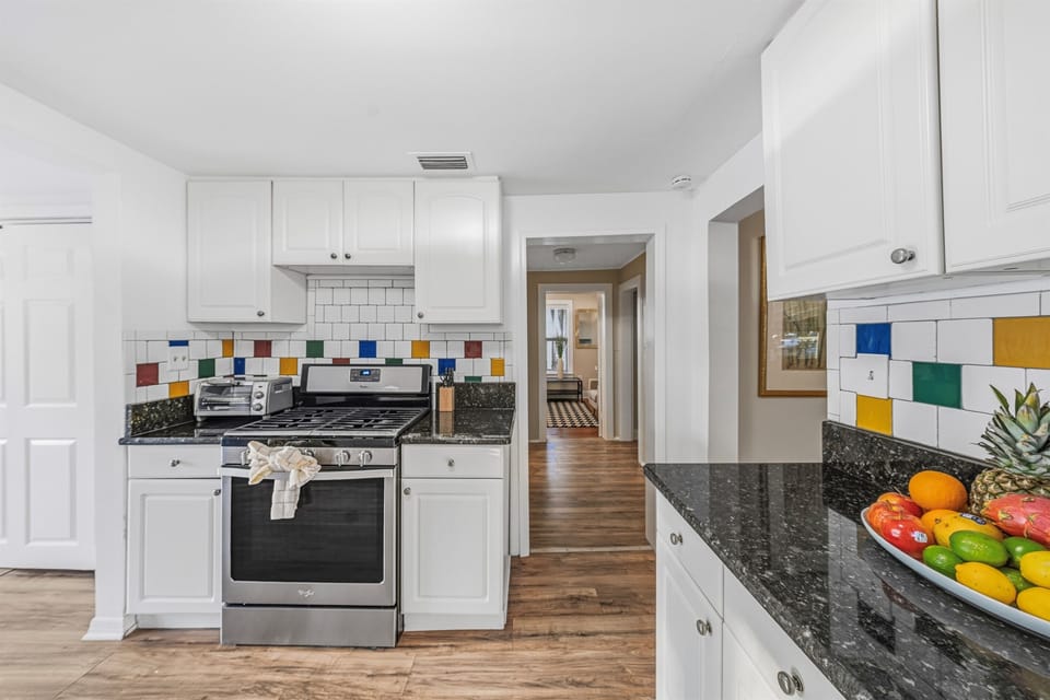 Open kitchen layout with stainless steel appliances and plenty of room to cook.