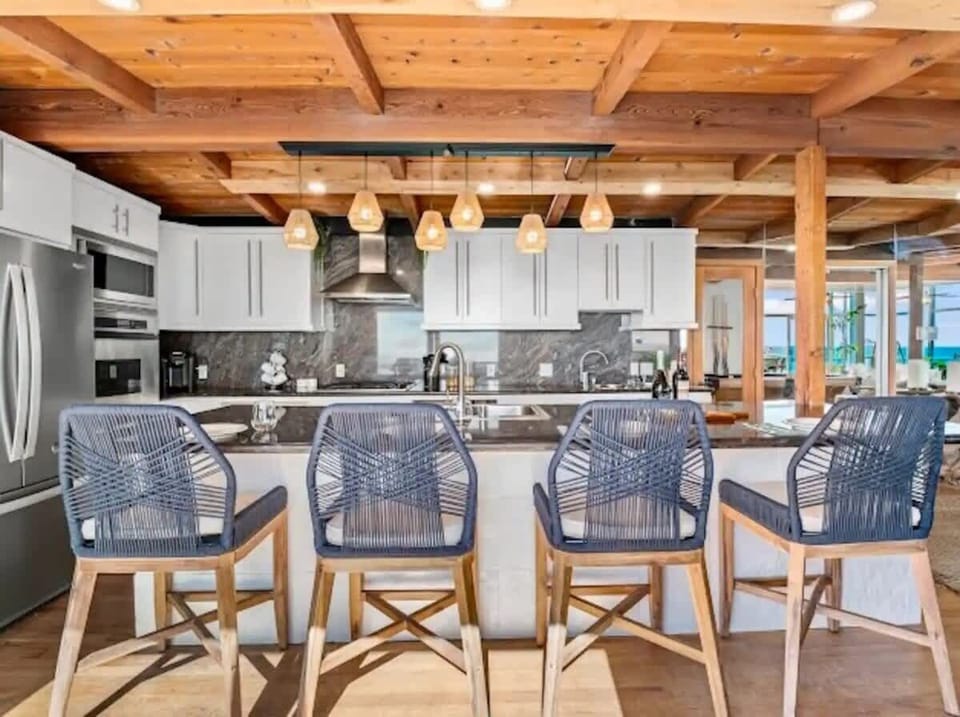 This coastal contemporary kitchen combines style and functionality perfect for cooking, entertaining, and enjoying the ocean breeze
