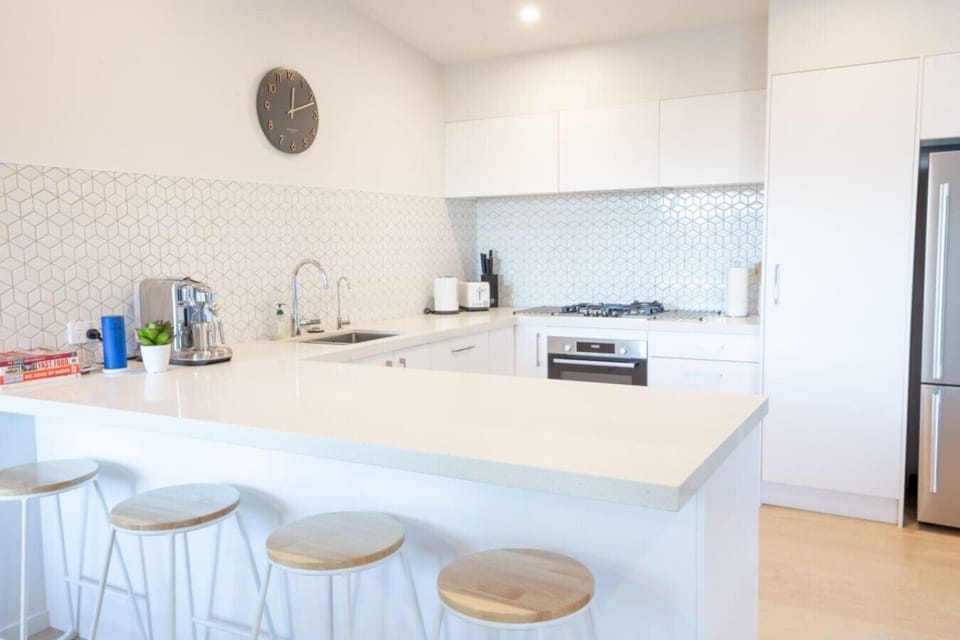 Kitchen area, large bench space for cooking, breakfast bar, high end coffee machine, essentials provided