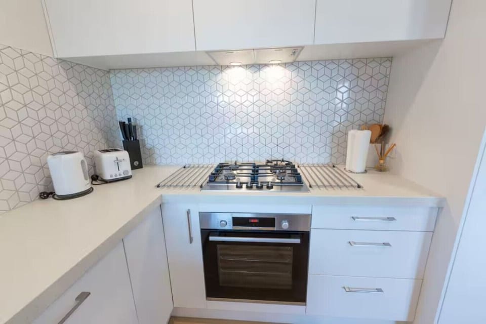 Kitchen with lots of bench space for cooking. Kitchen includes Bosch appliances (gas cooktop, oven and dishwasher), fridge/freezer, pantry, microwave
